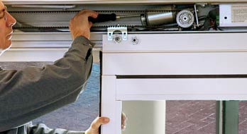 Man fixing an automatic sliding door